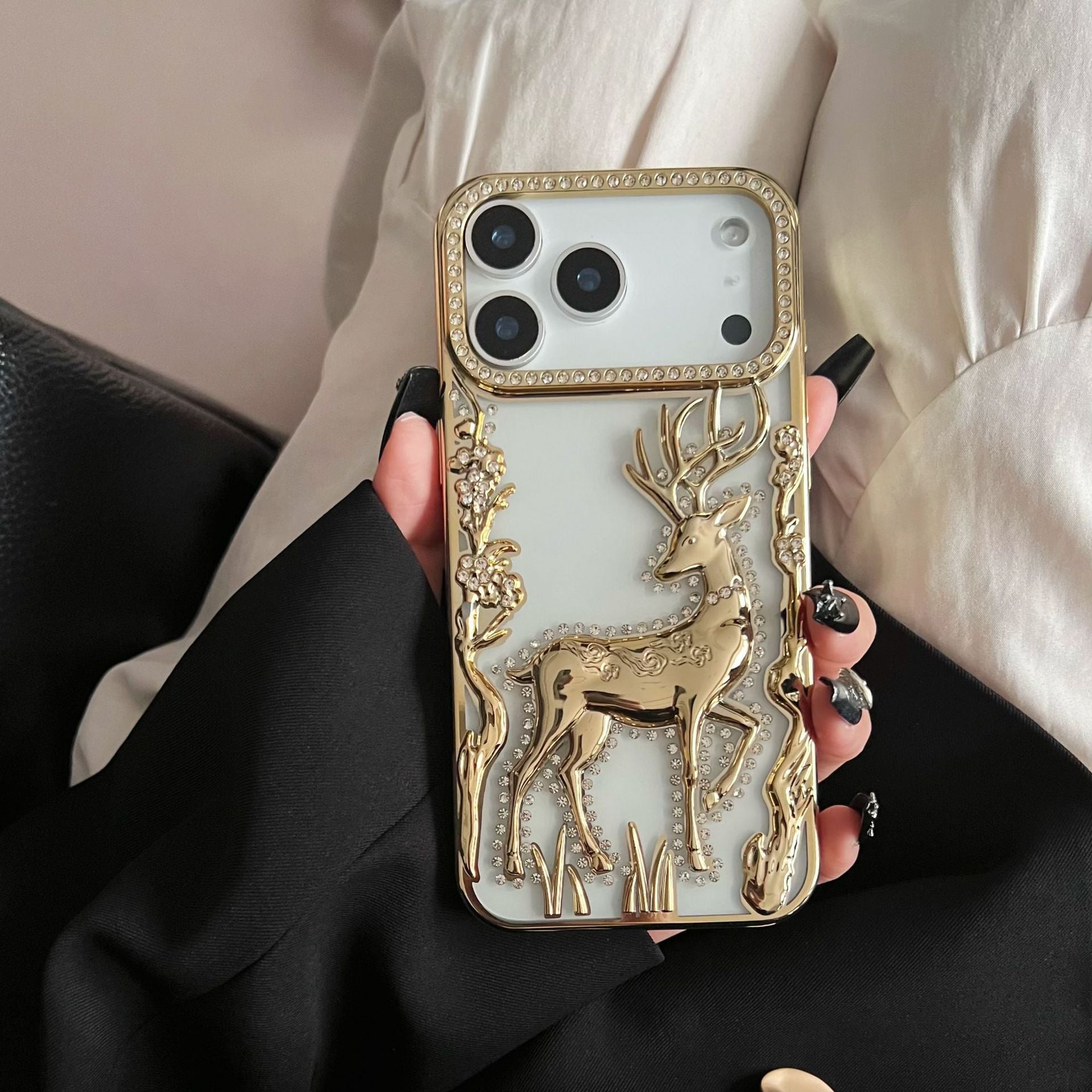Gold 3D Elk Hollow phone case by Miniic Shop, electroplated protective cover with intricate elk design on a smartphone.
