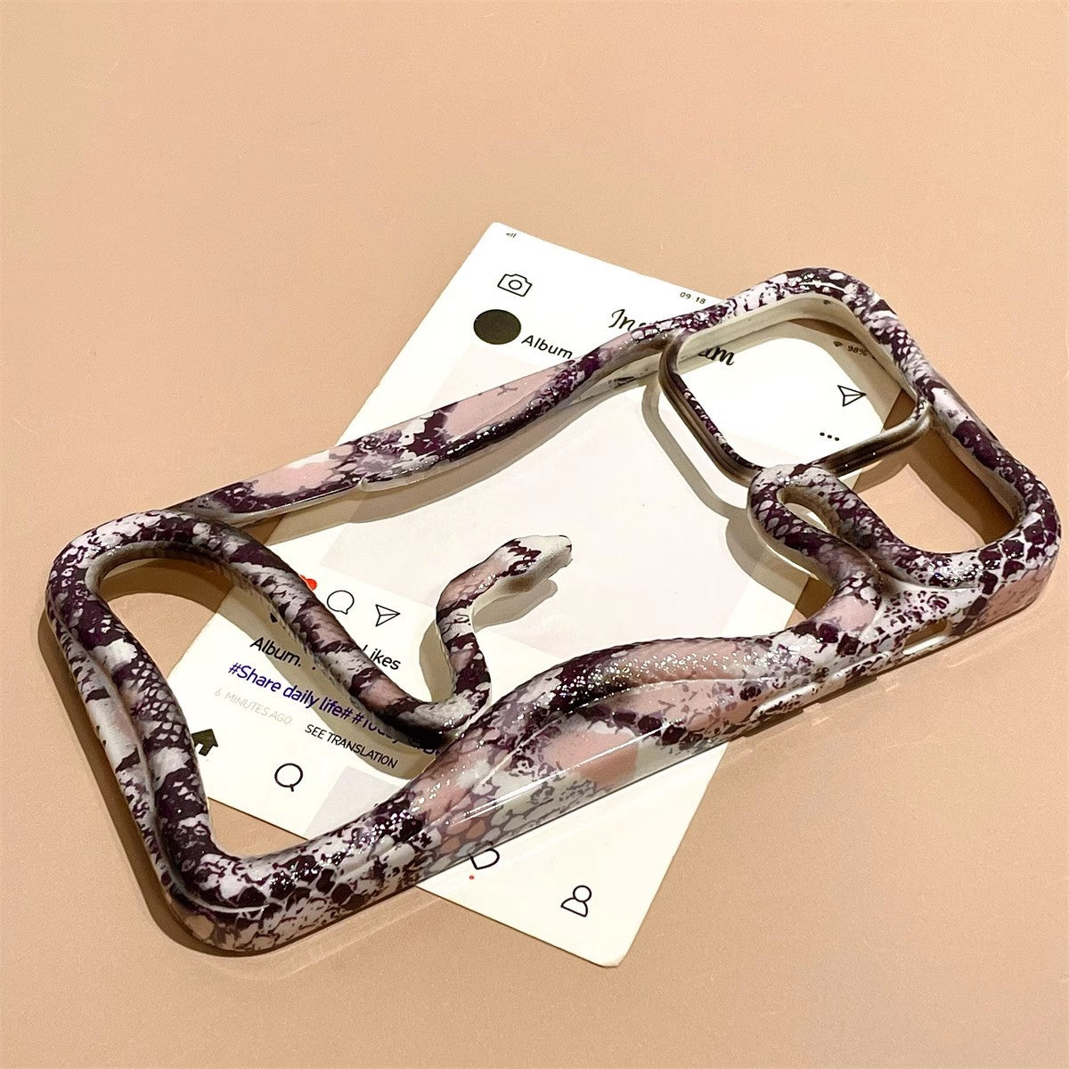 Snake print hollow out phone case with wavy frame design by Miniic Shop, showcasing a trendy, textured aesthetic.