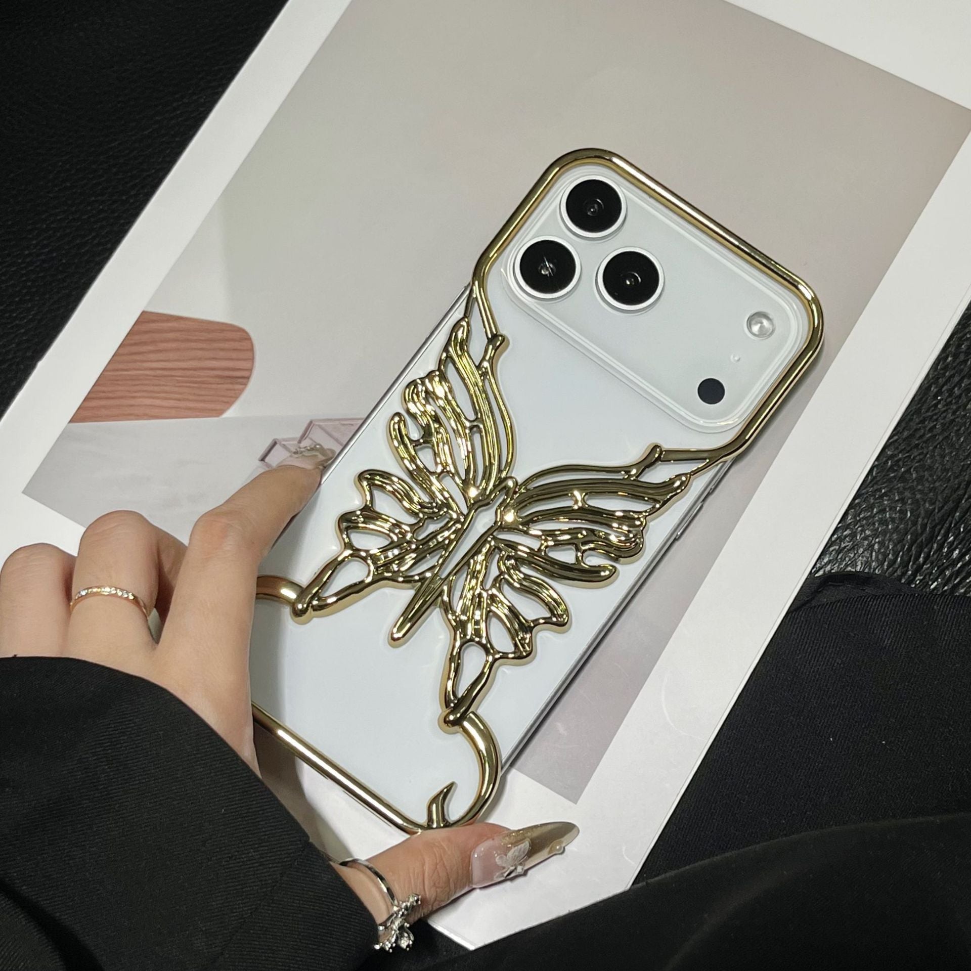 3D butterfly phone case with hollow out design by Miniic Shop, showcasing an intricate, aesthetic pattern on a smartphone.