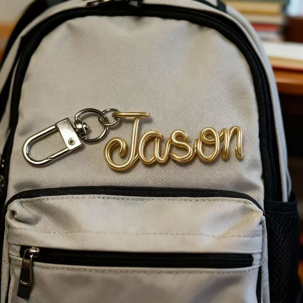 Personalized hand-bent wire name pendant with custom alphabet letter charm for bags, phones, or keychains by Miniic Shop.